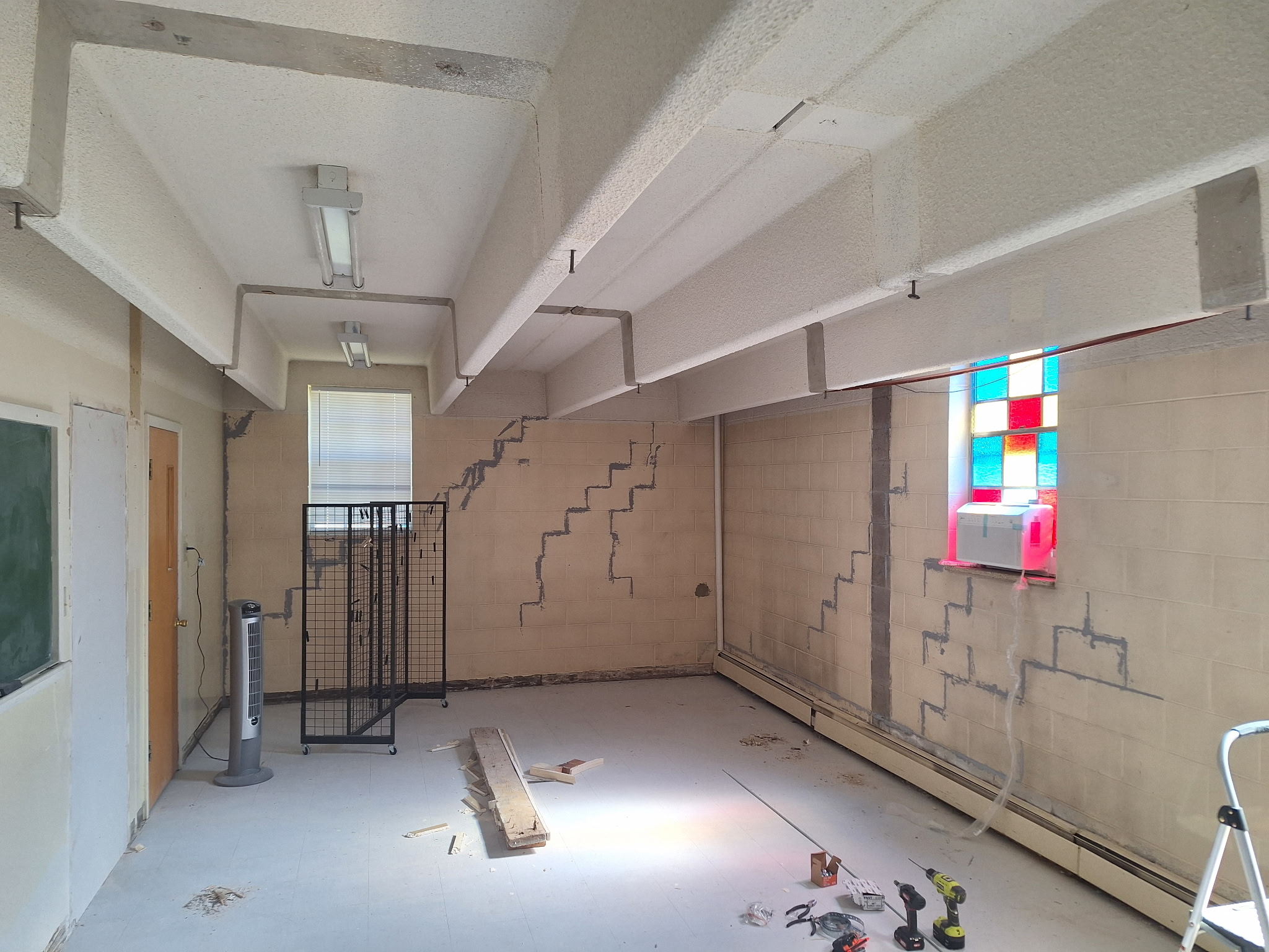 Interior of a private school before renovation - worn walls and flooring in need of repair